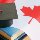 books and a graduation cap sitting on a Canadian flag